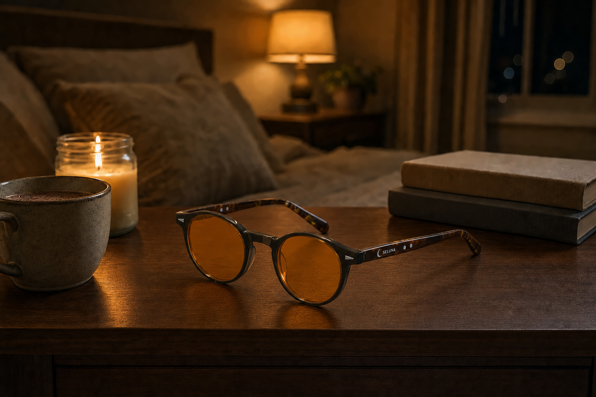 Amber evening glasses on a nightstand by candlelight